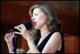 A person singing into a microphone

Description automatically generated
