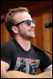 A person wearing sunglasses and a black shirt

Description automatically generated