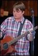 A person playing a guitar

Description automatically generated