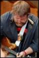 A person playing a guitar

Description automatically generated