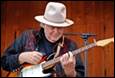A person playing a guitar

Description automatically generated