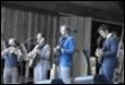 A group of people playing instruments

Description automatically generated