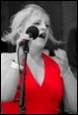 A person singing into a microphone

Description automatically generated