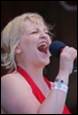 A person singing into a microphone

Description automatically generated
