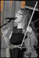 A person singing into a microphone

Description automatically generated