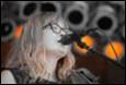 A person singing into a microphone

Description automatically generated