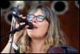 A person singing into a microphone

Description automatically generated