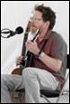 A person playing a guitar

Description automatically generated