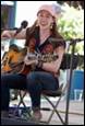 A person playing guitar and singing

Description automatically generated