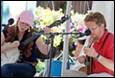 A person and person playing instruments

Description automatically generated