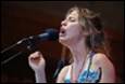 A person singing into a microphone

Description automatically generated