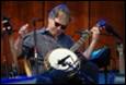 A person playing a banjo

Description automatically generated