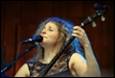 A person singing into a microphone

Description automatically generated