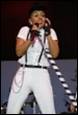 A person singing into a microphone

Description automatically generated