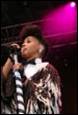 A person singing into a microphone

Description automatically generated