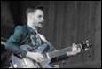 A person playing a guitar

Description automatically generated
