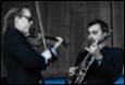 A group of men playing instruments

Description automatically generated