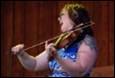 A person playing a violin

Description automatically generated