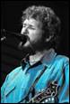 A person singing into a microphone

Description automatically generated