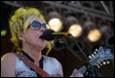 A person singing into a microphone

Description automatically generated