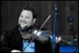 A person holding a violin

Description automatically generated