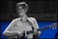 A person playing a guitar

Description automatically generated