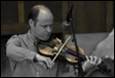 A person playing a violin

Description automatically generated