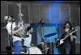 A group of people playing instruments

Description automatically generated