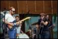 A group of people playing instruments

Description automatically generated