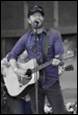 A person playing guitar and singing

Description automatically generated