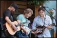 A group of people playing instruments

Description automatically generated