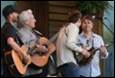 A group of people playing guitars

Description automatically generated