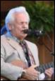 A person singing into a microphone

Description automatically generated