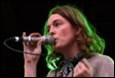 A person singing into a microphone

Description automatically generated
