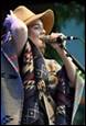 A person singing into a microphone

Description automatically generated