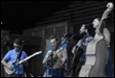 A group of people playing instruments

Description automatically generated