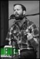 A person with a microphone in his mouth

Description automatically generated