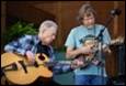A group of men playing guitars

Description automatically generated
