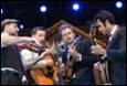 A group of people playing instruments

Description automatically generated