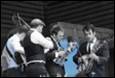 A group of men playing musical instruments

Description automatically generated