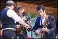 A group of men playing instruments

Description automatically generated