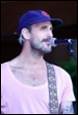 A person with a hat and a microphone

Description automatically generated