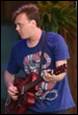 A person playing a guitar

Description automatically generated