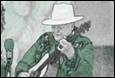 A person in a hat playing a guitar

Description automatically generated
