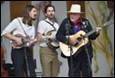 A group of men playing instruments

Description automatically generated