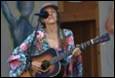 A person playing guitar and singing

Description automatically generated