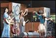 A group of people performing on a stage

Description automatically generated