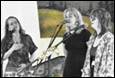 A group of women singing into microphones

Description automatically generated