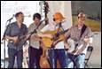 A group of men playing instruments

Description automatically generated