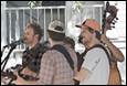 A group of men playing instruments

Description automatically generated
